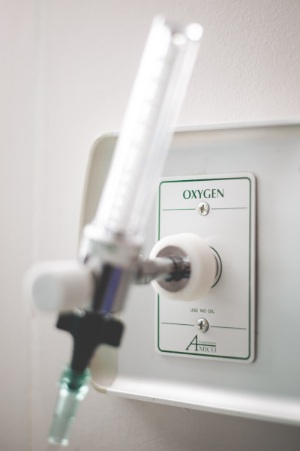 Concentrador de oxigeno conectado a la fuente de oxigeno en la pared.